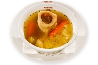 Broth with marrowbone, toast,vegetables and vermicelli in a bowl - 