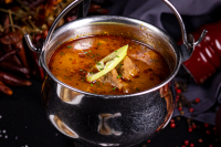 Hungarian gulyás soup served in a stewing pot - 