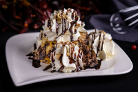 Delicacy of Somló with whipped cream, chocolate sauce and walnut sprinkling - 