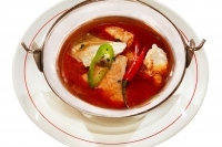 Fish soup á la Szeged with carp fillet and with carp offal served in stewing pot - 